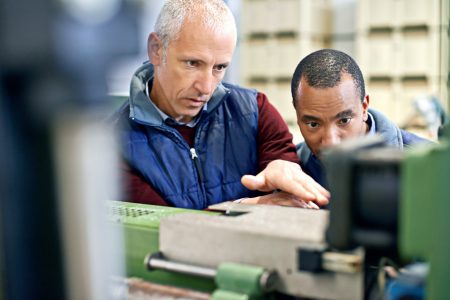 Were only as good as our equipment. Shot of two men working over Travail industriel sur une machine spéciale dans l'industrie avec Open-Prod
